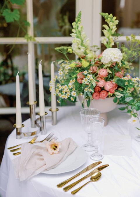 Hochzeitswahn - Eine weiße Tischdecke mit Blumen darauf.